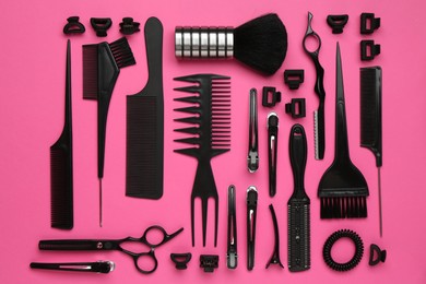 Photo of Different hairdresser's tools on pink background, flat lay
