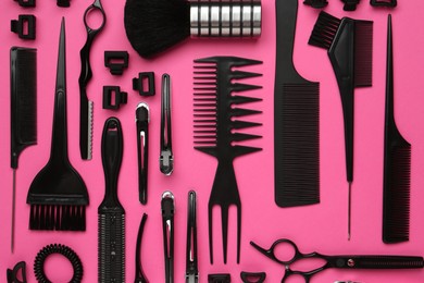 Photo of Different hairdresser's tools on pink background, flat lay
