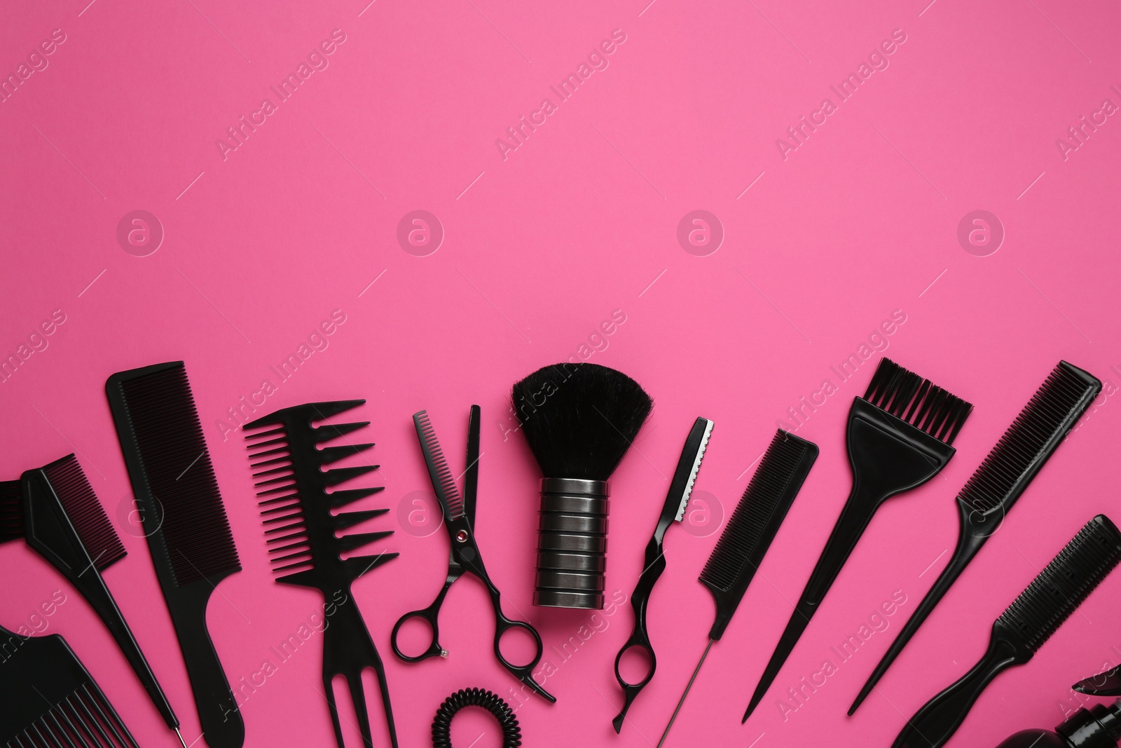 Photo of Different hairdresser's tools on pink background, flat lay. Space for text