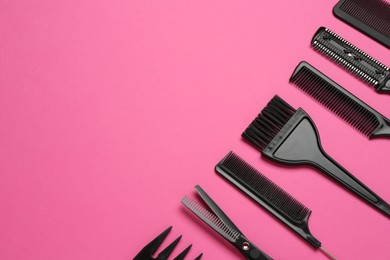 Photo of Different hairdresser's tools on pink background, flat lay. Space for text