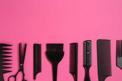 Photo of Different hairdresser's tools on pink background, flat lay. Space for text