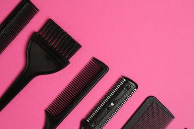 Photo of Different hairdresser's tools on pink background, flat lay. Space for text