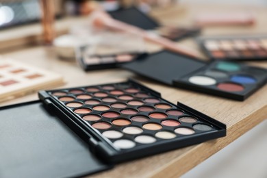 Photo of Different makeup products on vanity indoors, closeup