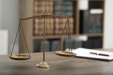 Photo of Judge's workplace with scales and clipboard on wooden table in office, closeup