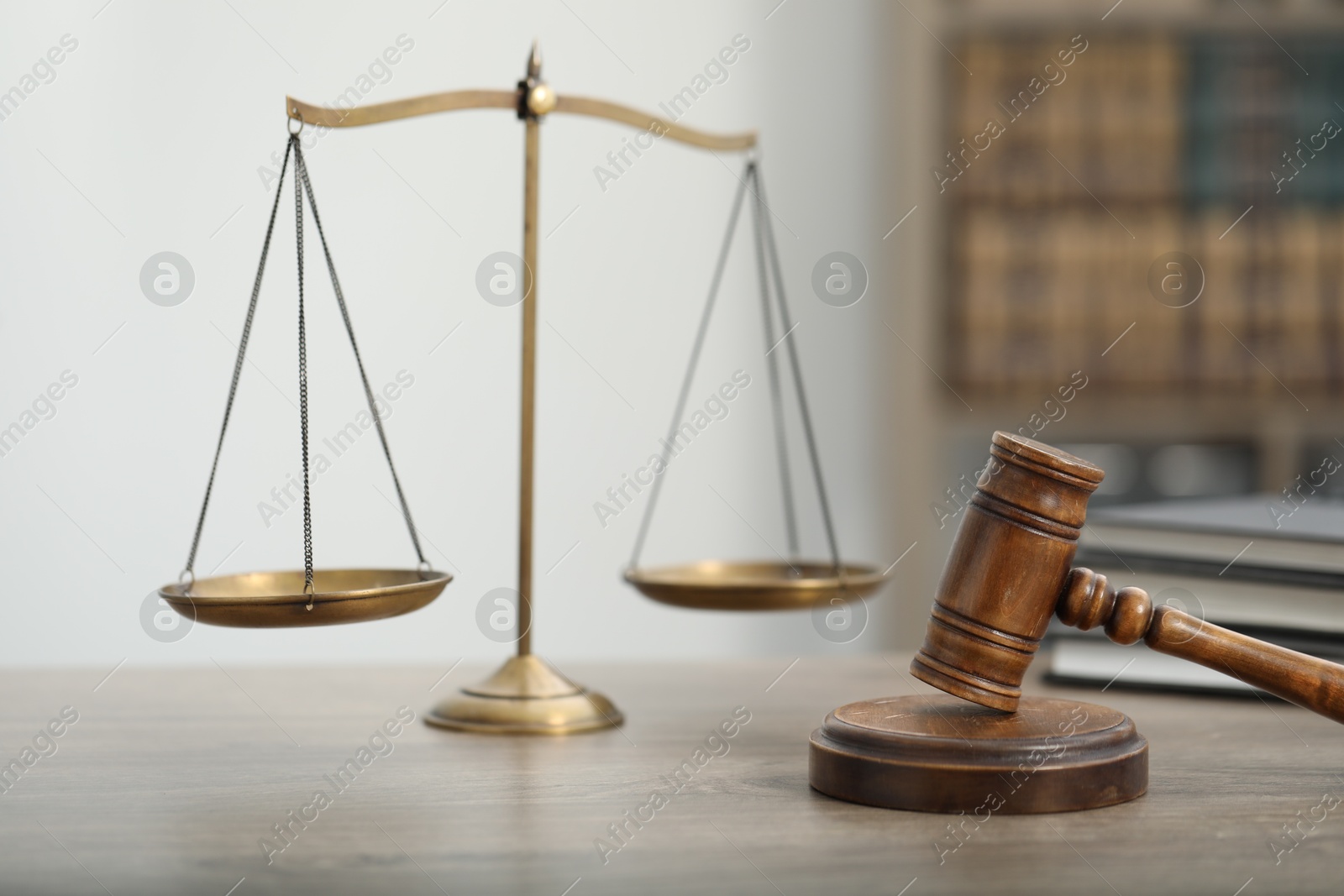 Judge's gavel, books and scales on wooden table in office, closeup Photo of Judge's gavel, books and scales on wooden table in office, closeup
