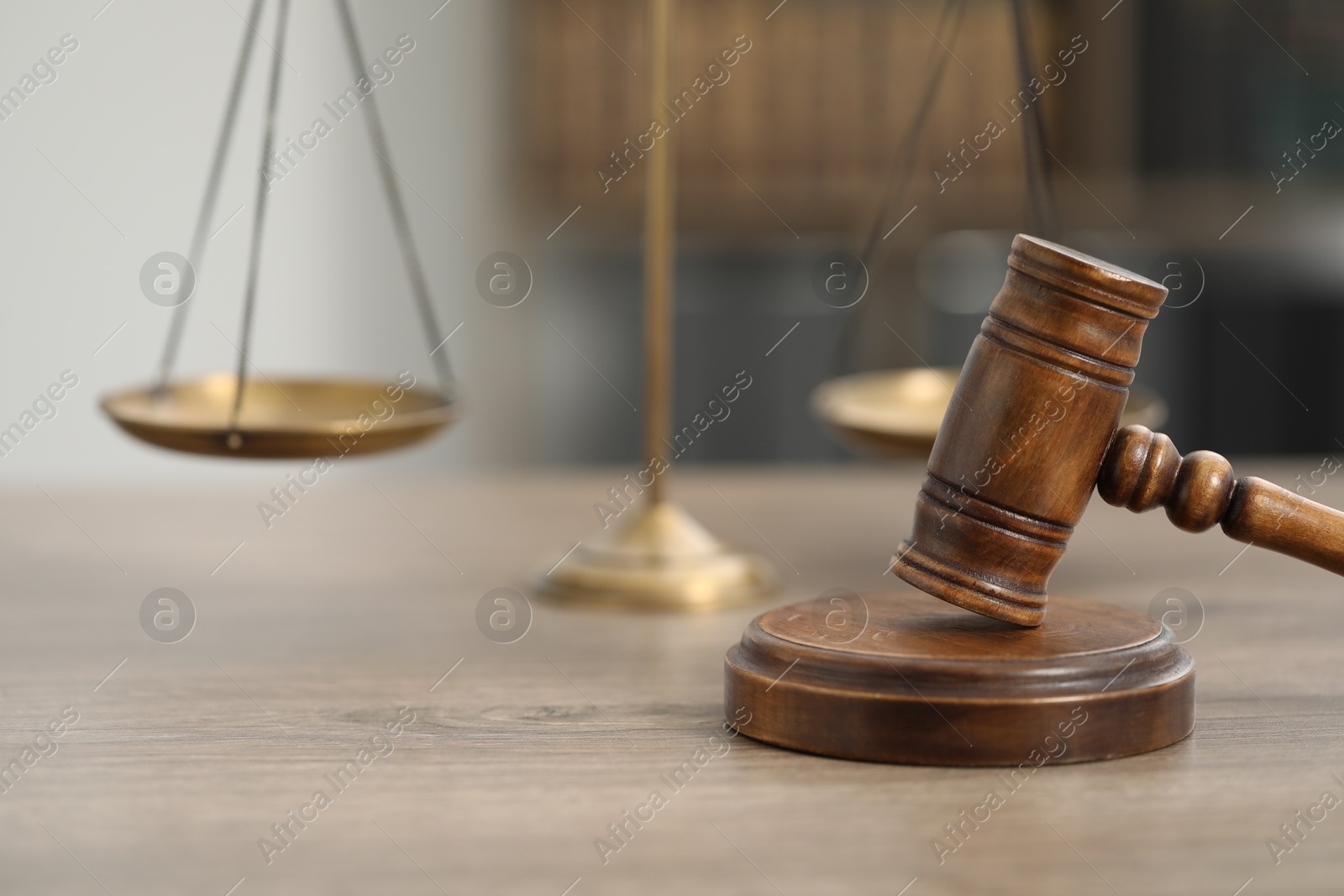 Judge's gavel and scales on wooden table in office, closeup Photo of Judge's gavel and scales on wooden table in office, closeup