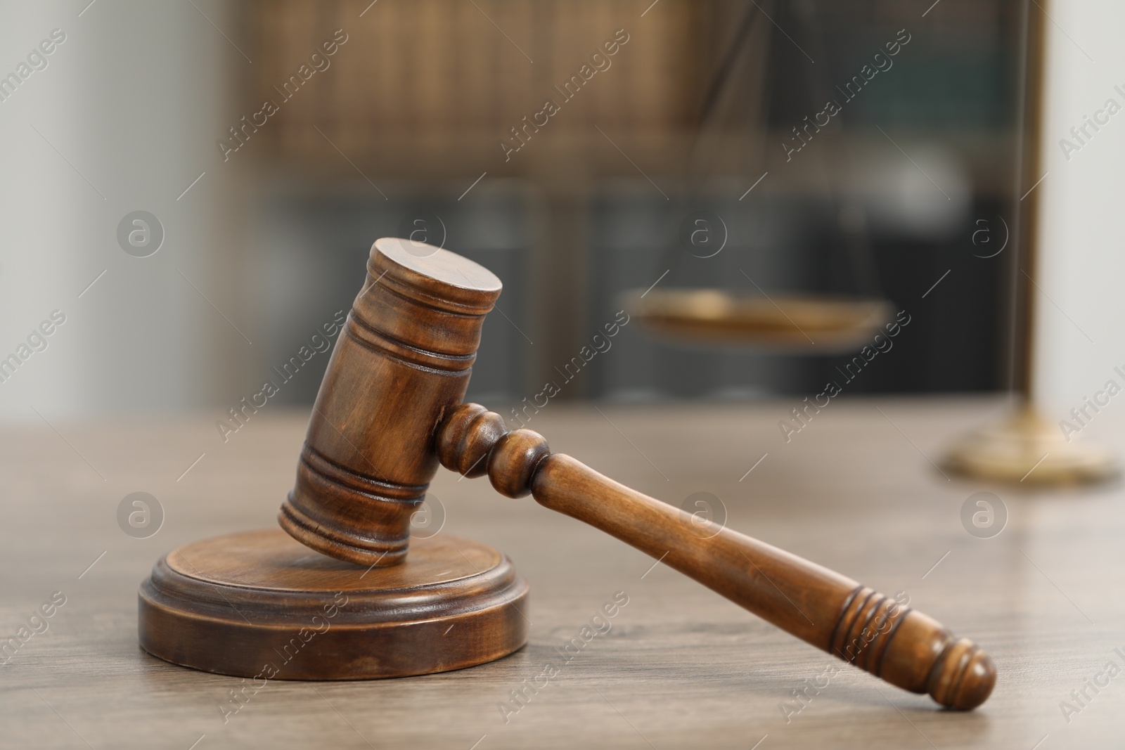 Judge's gavel and scales on wooden table in office, closeup Photo of Judge's gavel and scales on wooden table in office, closeup