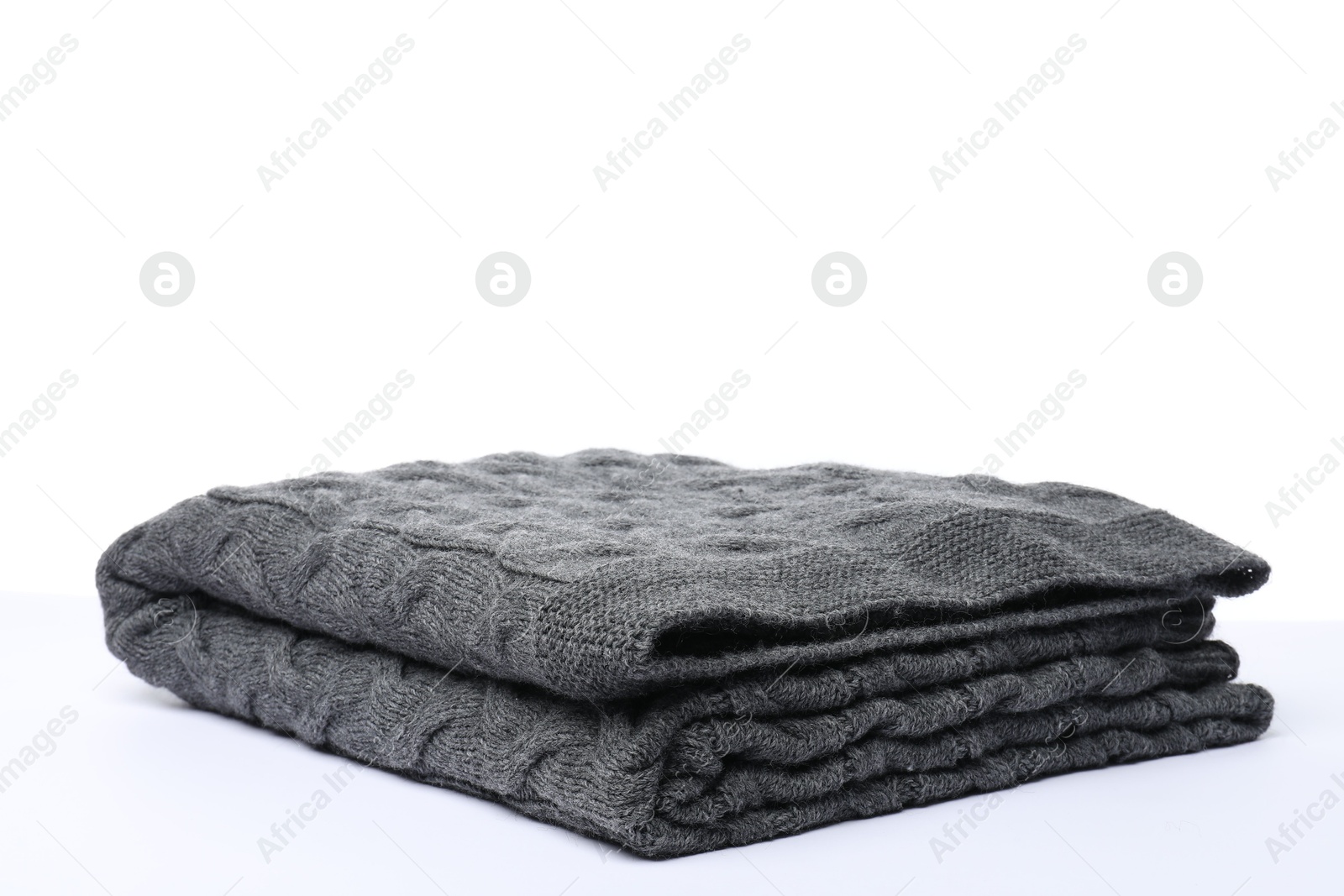Folded grey woolen blanket on white background Photo of Folded grey woolen blanket on white background