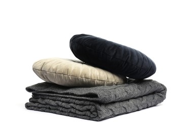 Photo of Folded grey blanket and pillows isolated on white