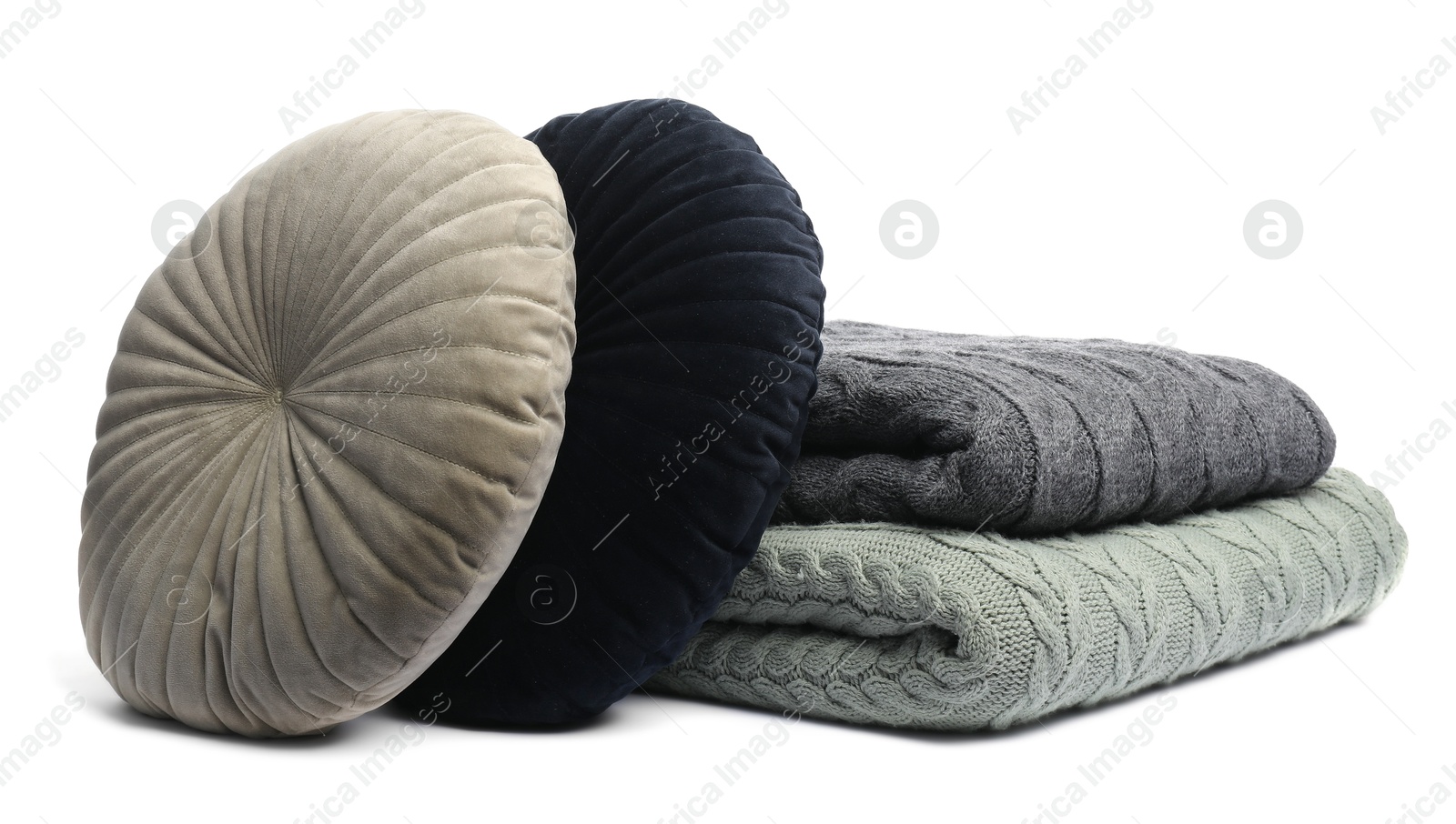 Folded woolen blankets and pillows isolated on white Photo of Folded woolen blankets and pillows isolated on white