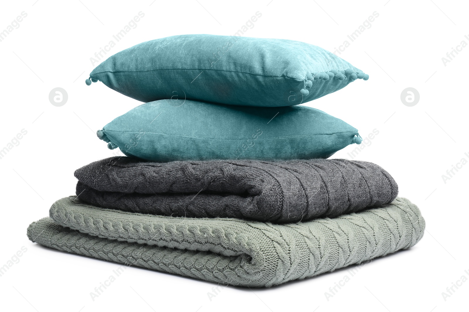 Folded woolen blankets and pillows isolated on white Photo of Folded woolen blankets and pillows isolated on white