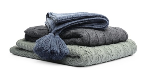 Photo of Stack of folded blankets isolated on white