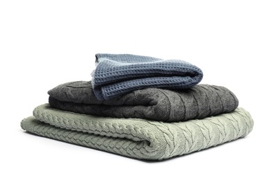 Photo of Stack of folded blankets isolated on white