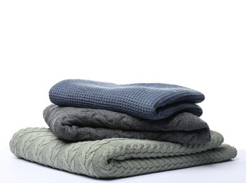 Photo of Stack of folded blankets on white background