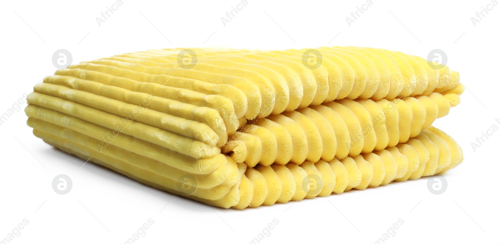 Folded yellow woolen blanket isolated on white Photo of Folded yellow woolen blanket isolated on white