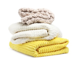 Photo of Stack of folded blankets isolated on white