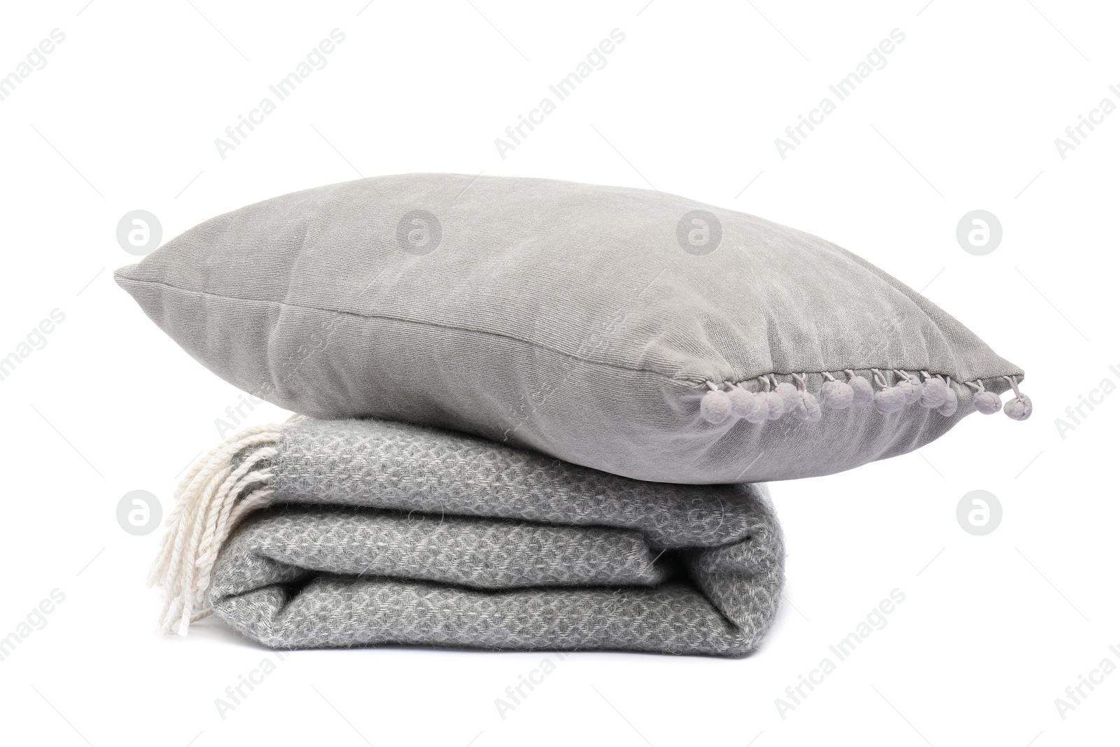 Folded woolen blanket and pillow isolated on white Photo of Folded woolen blanket and pillow isolated on white