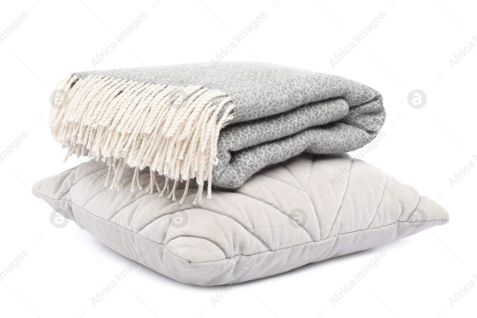 Folded woolen blanket and pillow isolated on white Photo of Folded woolen blanket and pillow isolated on white