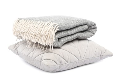 Photo of Folded woolen blanket and pillow isolated on white