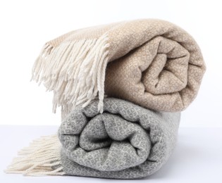 Photo of Two folded woolen blankets on white background