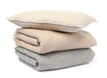 Photo of Folded woolen blankets and pillow isolated on white