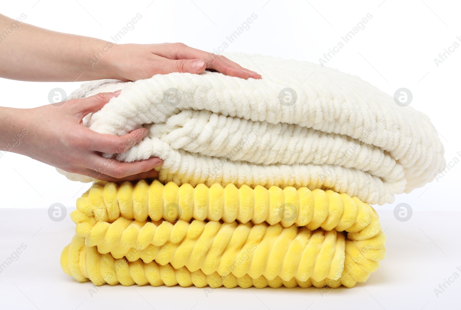 Woman with folded blankets on white background, closeup Photo of Woman with folded blankets on white background, closeup