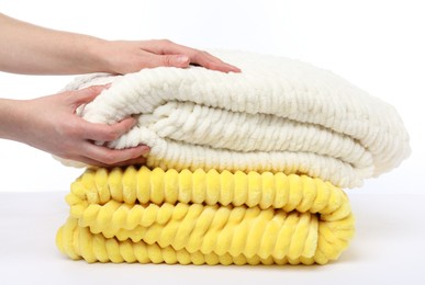 Photo of Woman with folded blankets on white background, closeup