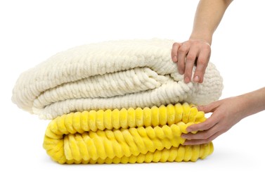 Photo of Woman with folded blankets on white background, closeup