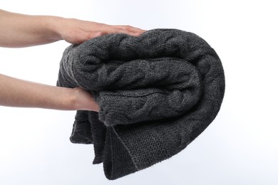 Photo of Woman with folded grey blanket on white background, closeup