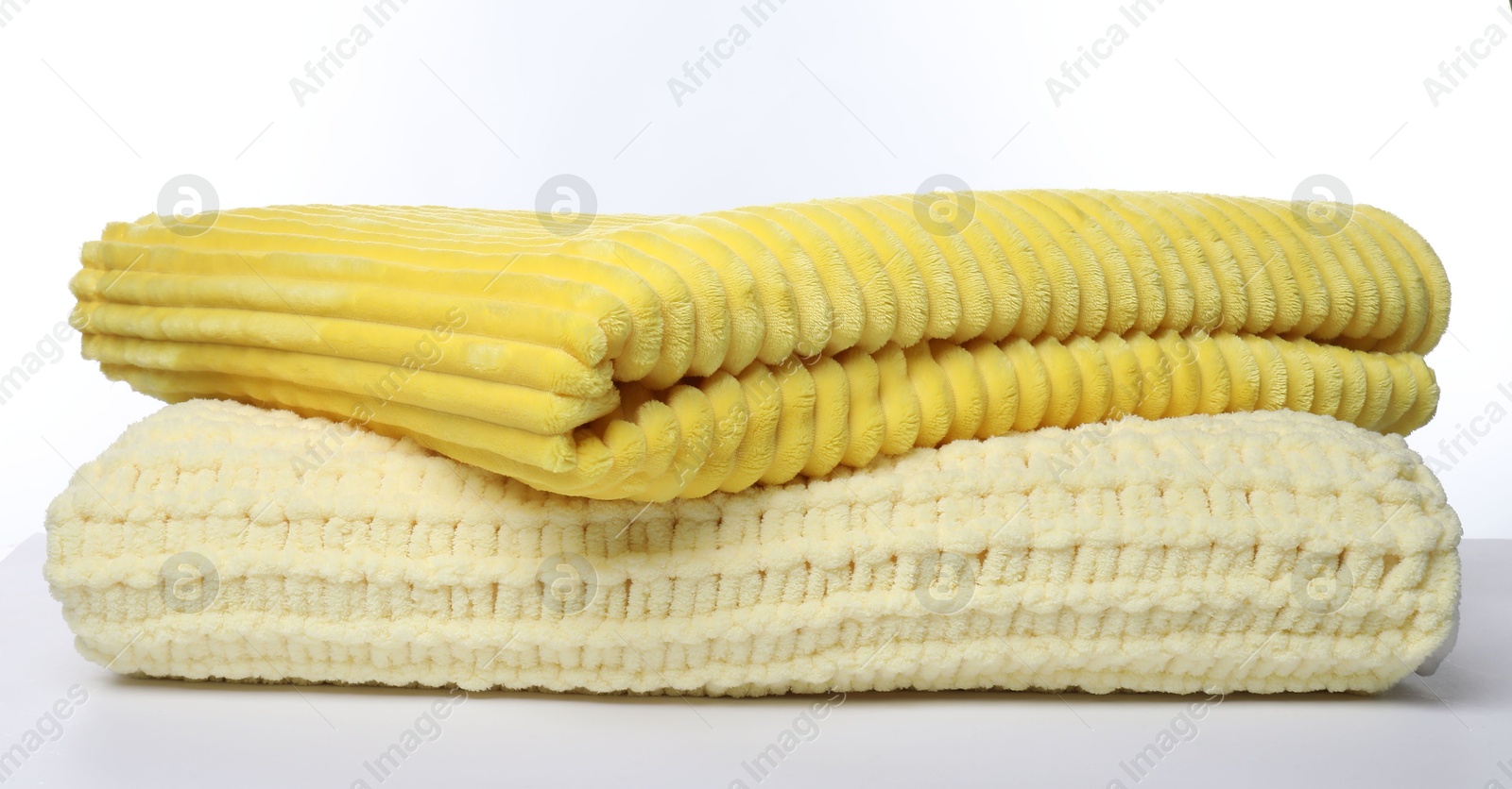 Two folded woolen blankets on white background Photo of Two folded woolen blankets on white background