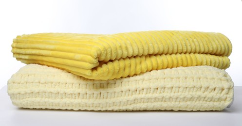 Photo of Two folded woolen blankets on white background