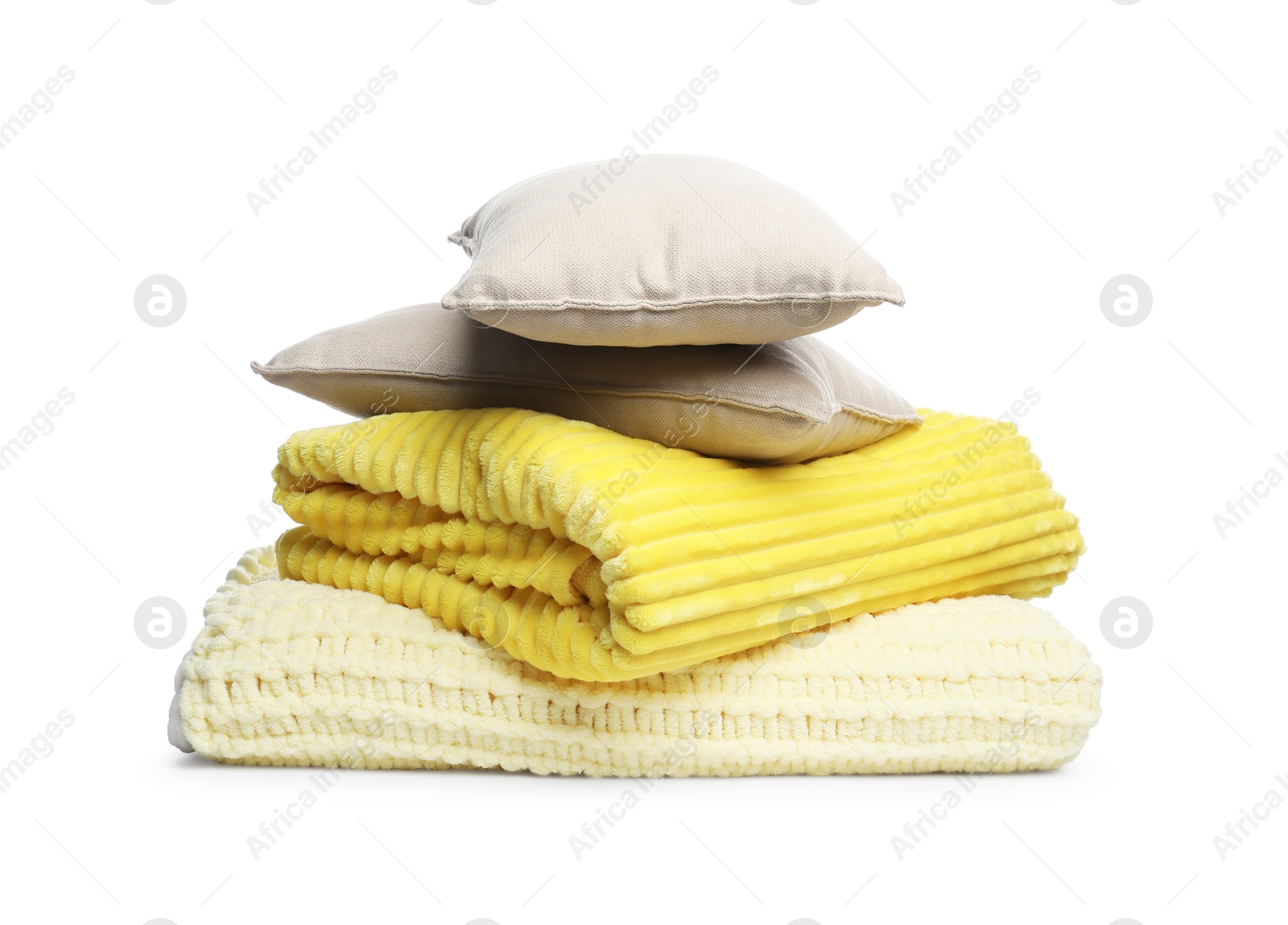 Folded woolen blankets and pillows isolated on white Photo of Folded woolen blankets and pillows isolated on white