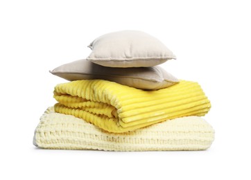 Photo of Folded woolen blankets and pillows isolated on white