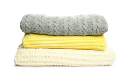 Photo of Stack of folded woolen blankets isolated on white