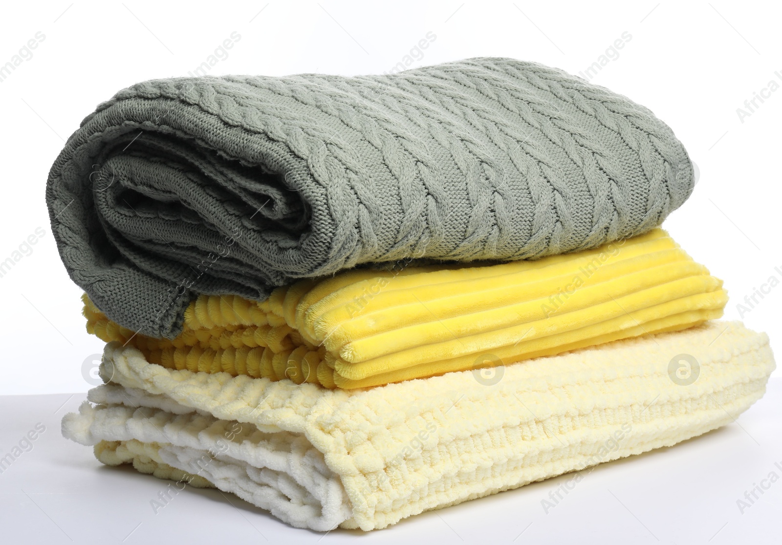 Stack of folded woolen blankets on white background Photo of Stack of folded woolen blankets on white background
