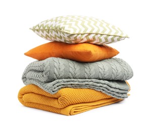 Photo of Folded woolen blankets and pillows isolated on white