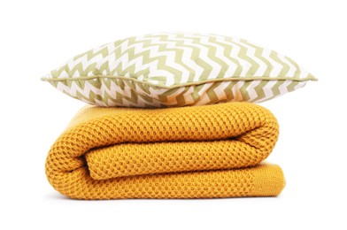 Photo of Folded woolen blanket and pillow isolated on white