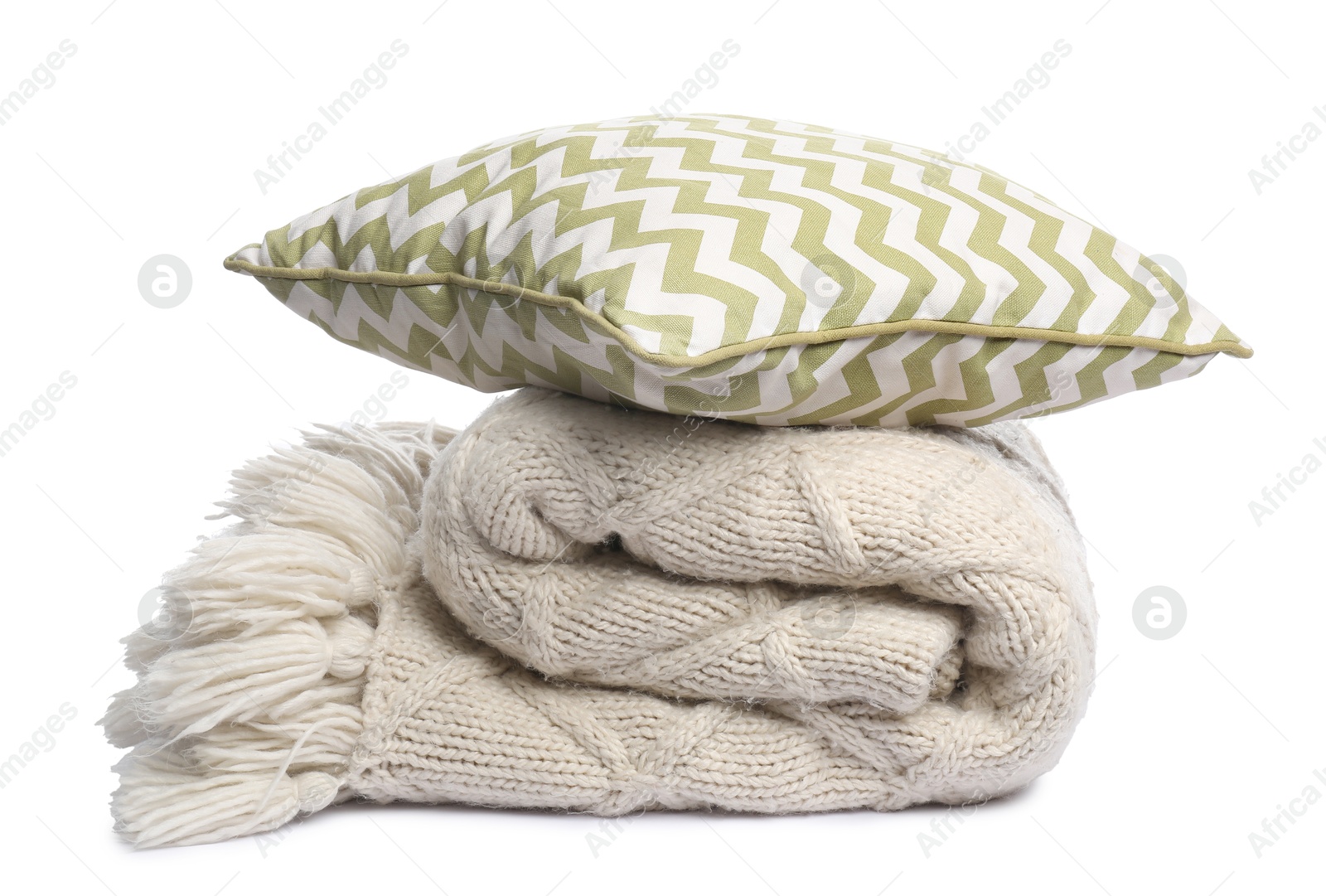 Folded woolen blanket and pillow isolated on white Photo of Folded woolen blanket and pillow isolated on white
