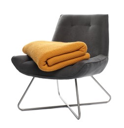 Photo of Comfortable armchair with blanket isolated on white