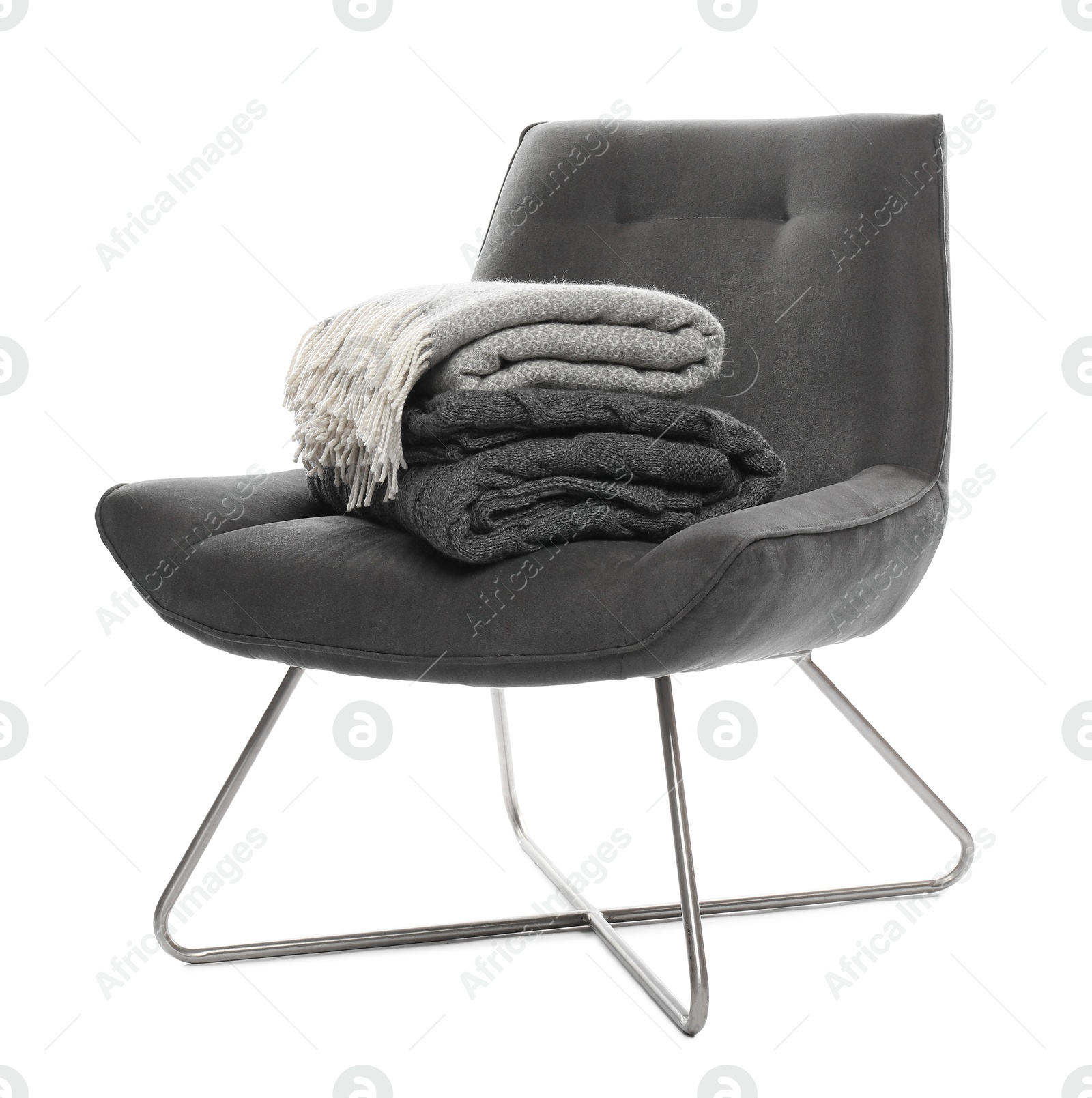 Comfortable armchair with blankets isolated on white Photo of Comfortable armchair with blankets isolated on white