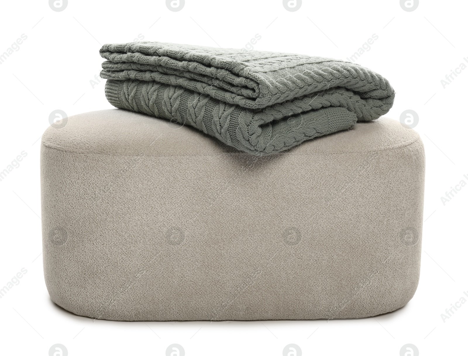 Pouf with folded blanket isolated on white Photo of Pouf with folded blanket isolated on white
