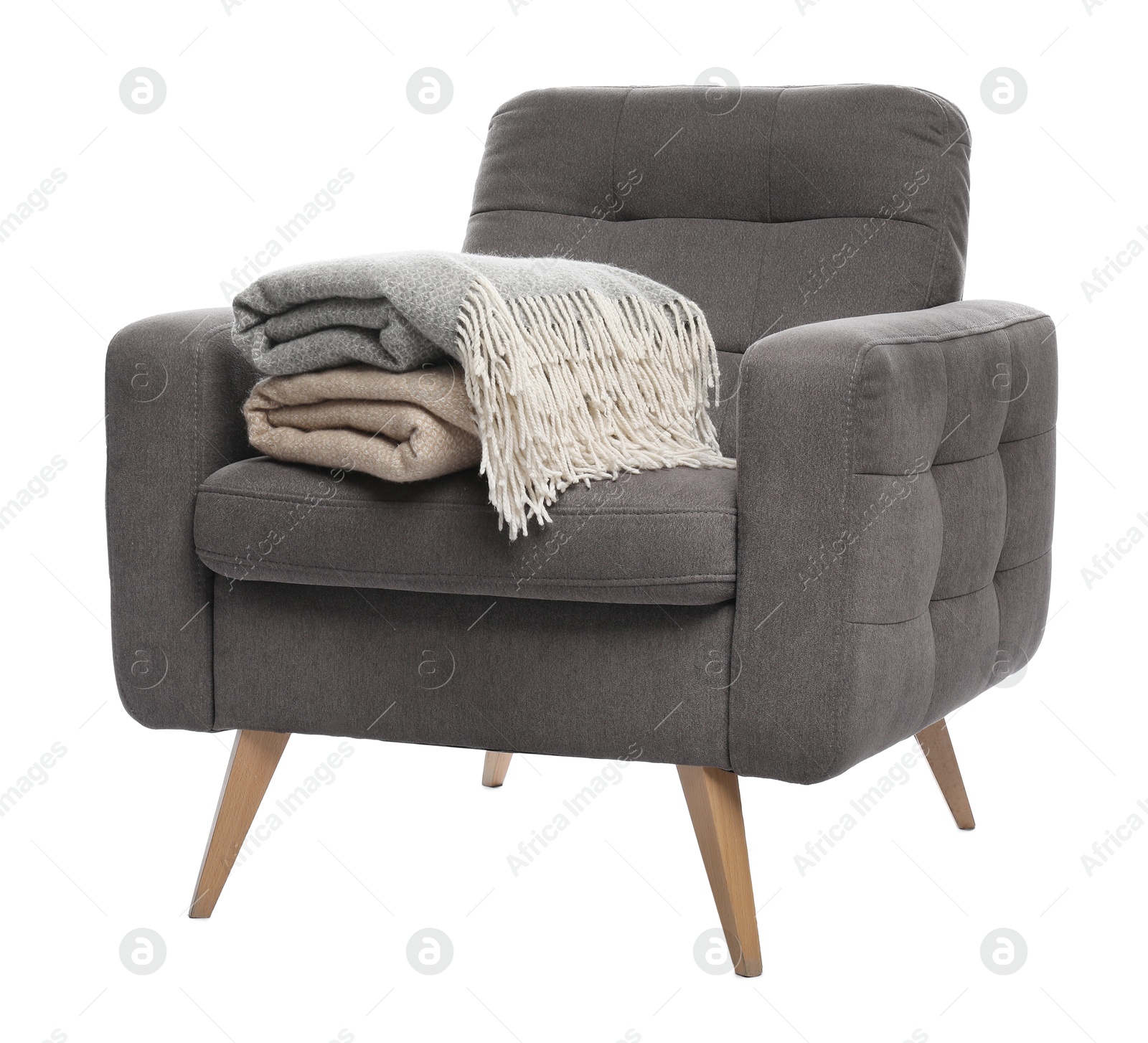 Comfortable armchair with blankets isolated on white Photo of Comfortable armchair with blankets isolated on white