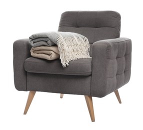 Photo of Comfortable armchair with blankets isolated on white