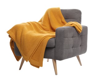 Photo of Comfortable armchair with blanket isolated on white