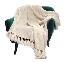 Photo of Comfortable armchair with blanket isolated on white