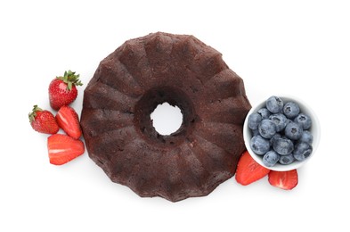 Photo of Tasty chocolate bundt cake with berries isolated on white, top view