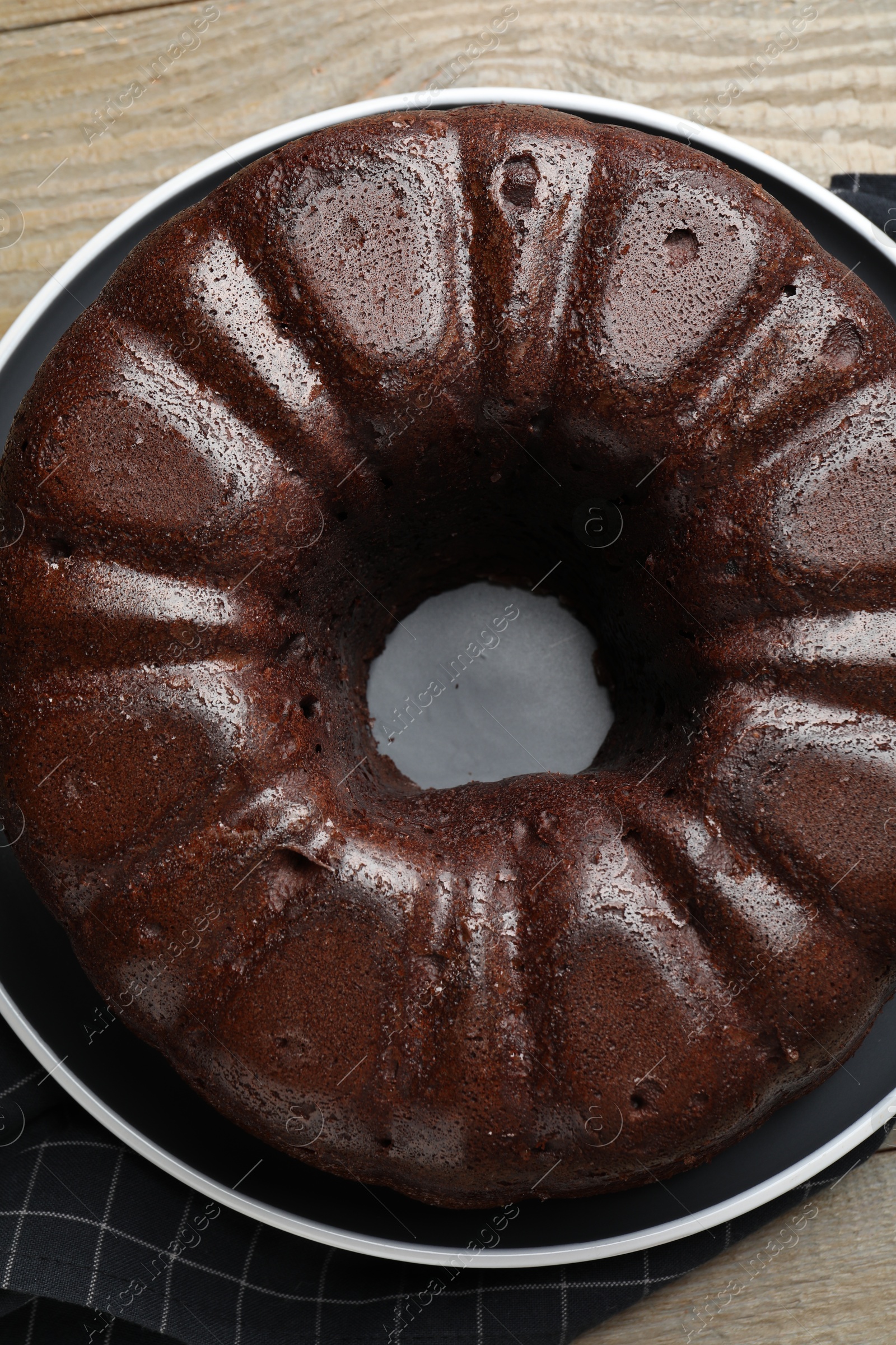Tasty chocolate bundt cake on wooden table, top view Photo of Tasty chocolate bundt cake on wooden table, top view