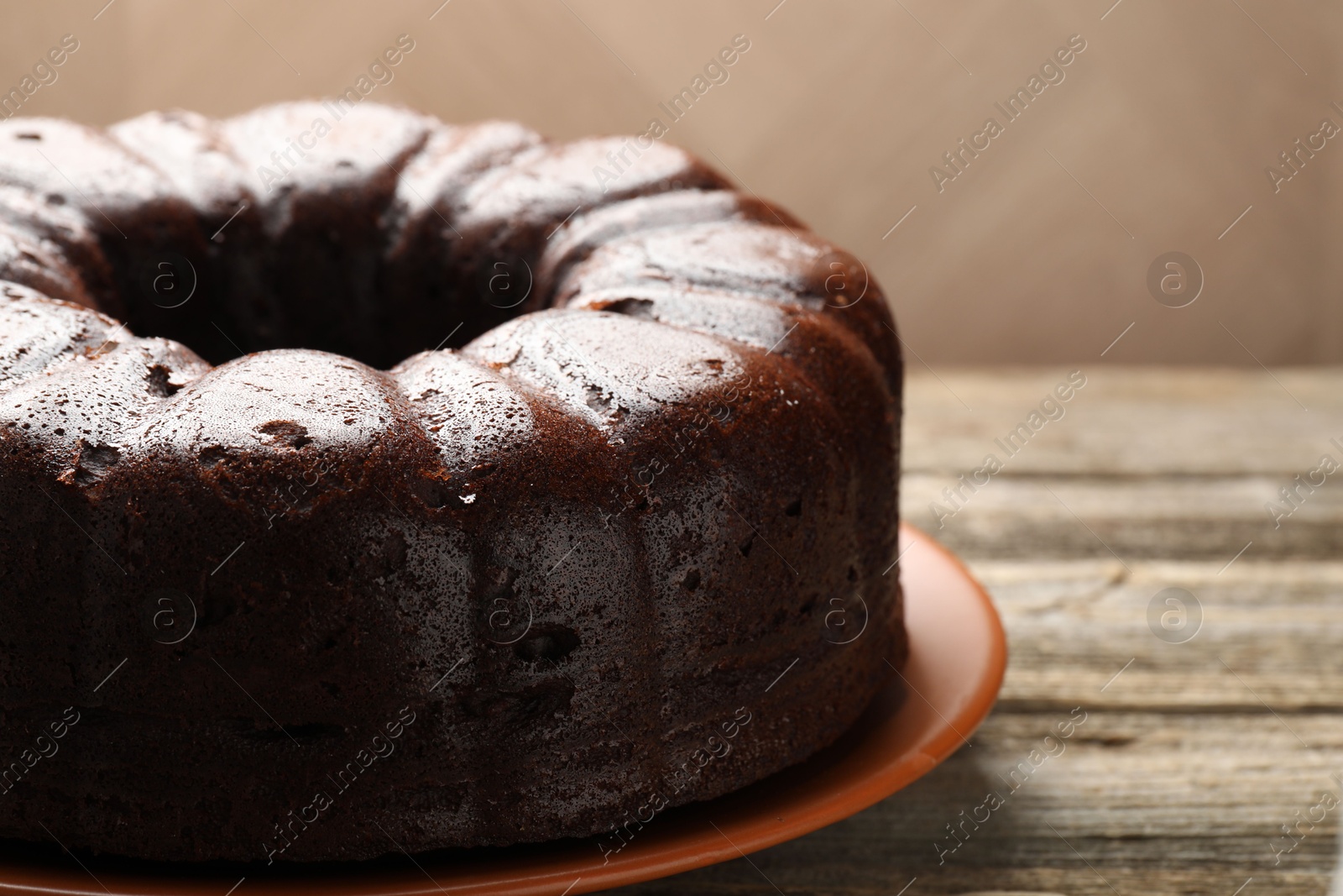 Tasty chocolate bundt cake on wooden table, closeup Photo of Tasty chocolate bundt cake on wooden table, closeup