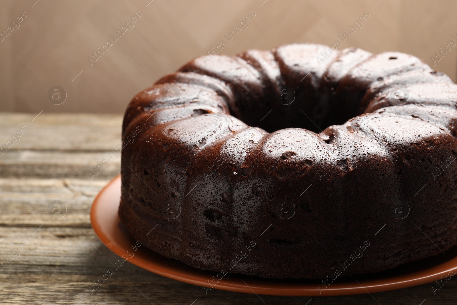 Tasty chocolate bundt cake on wooden table, closeup Photo of Tasty chocolate bundt cake on wooden table, closeup