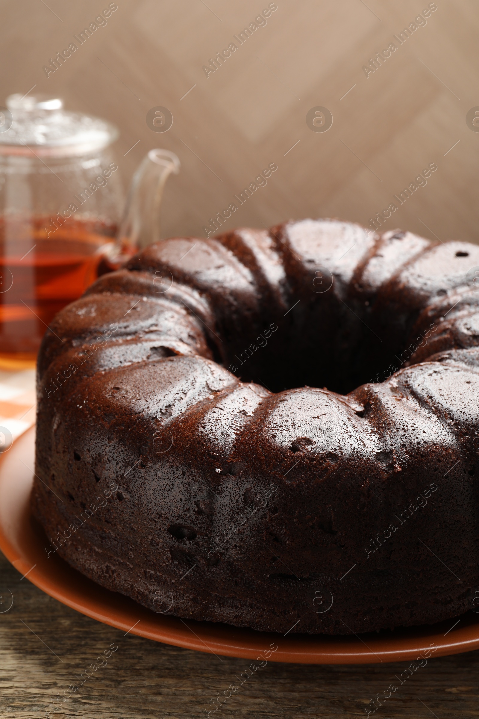 Tasty chocolate bundt cake on wooden table, closeup Photo of Tasty chocolate bundt cake on wooden table, closeup